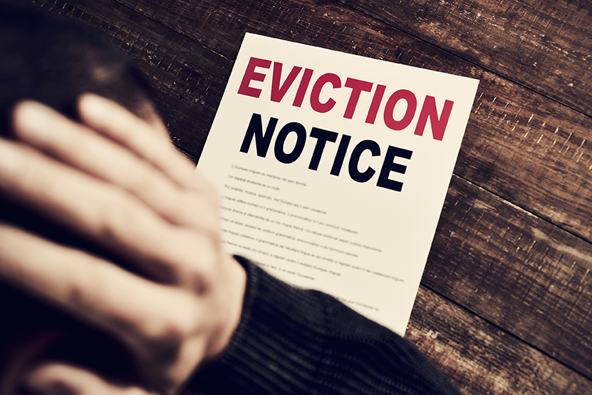 eviction_notice_man_at_table.jpg