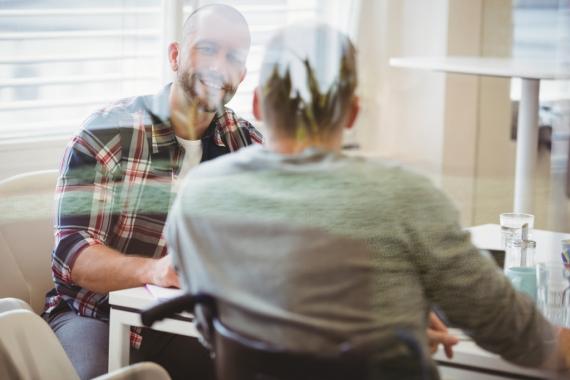 handicap-businessman-discussing-with-colleague-in-office-picture-id658902064_1.jpg