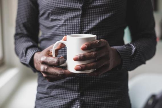 man-holds-mug_925x.jpg