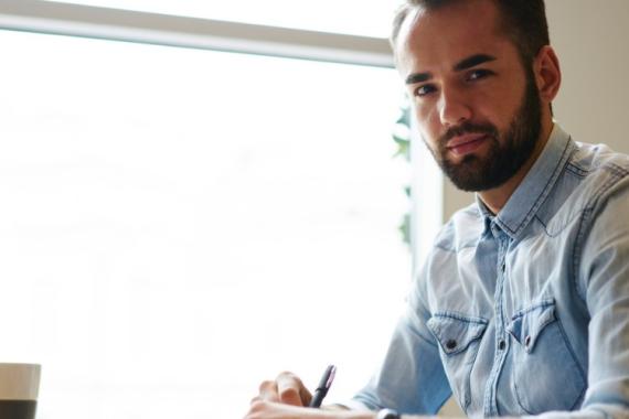 portrait-of-young-bearded-entrepreneur-working-remote-at-laptop-in-picture-id904869292.jpg